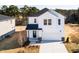 Aerial view of a two-story home with white siding, a dark roof, and a two-car garage at 70 Little Creek Dr, Lillington, NC 27546