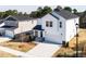 Aerial view of a two-story home with white siding, a black roof, and a two-car garage at 70 Little Creek Dr, Lillington, NC 27546