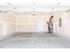 Spacious two-car garage with concrete floor, unfinished walls, and electric water heater at 70 Little Creek Dr, Lillington, NC 27546