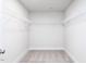 Walk-in closet with carpeted floor, white walls, and metal shelving at 70 Little Creek Dr, Lillington, NC 27546