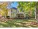Green backyard with a lovely screened in porch and trees providing shade at 413 Chadwick Ln, Efland, NC 27243