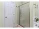 Bright bathroom features a large glass shower, neutral paint, and ceramic tile flooring at 413 Chadwick Ln, Efland, NC 27243
