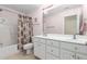 Bathroom with double sink vanity, tile floors, and shower-tub combination at 413 Chadwick Ln, Efland, NC 27243