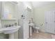 Bright bathroom featuring double sinks, neutral paint, and ceramic tile flooring at 413 Chadwick Ln, Efland, NC 27243