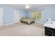 This light blue bedroom has a ceiling fan and good light at 413 Chadwick Ln, Efland, NC 27243