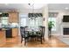 Cozy dining area with black chairs, natural light, hardwood flooring, with access to the kitchen and living room at 413 Chadwick Ln, Efland, NC 27243