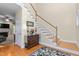 Welcoming foyer with hardwood floors, staircase, and decorative accents at 413 Chadwick Ln, Efland, NC 27243