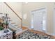 Bright foyer with hardwood floors, staircase, and ample natural light from the front door sidelights at 413 Chadwick Ln, Efland, NC 27243