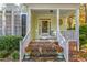 Inviting front porch with brick steps and beautifully decorated flower pots leading to the front door at 413 Chadwick Ln, Efland, NC 27243