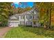 Charming two-story home with a manicured front lawn, two-car garage, and traditional curb appeal at 413 Chadwick Ln, Efland, NC 27243