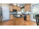 Bright kitchen features wood cabinets, granite countertops, stainless appliances, tile backsplash, and backyard access at 413 Chadwick Ln, Efland, NC 27243