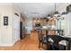 Eat-in kitchen featuring wooden cabinetry, stainless steel appliances, granite countertops, and dark chandelier fixture at 413 Chadwick Ln, Efland, NC 27243