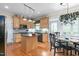 Charming eat-in kitchen showcasing granite countertops, hardwood floors, stainless appliances, and natural light at 413 Chadwick Ln, Efland, NC 27243