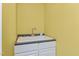 Laundry room features a sink with chrome faucet and white cabinets at 413 Chadwick Ln, Efland, NC 27243