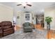 Comfortable living room featuring hardwood floors, accent rug, and cozy seating arrangement with decorative built-in shelving at 413 Chadwick Ln, Efland, NC 27243
