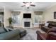 Cozy living room with a fireplace, comfortable seating, and natural light from the windows at 413 Chadwick Ln, Efland, NC 27243
