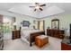 Cozy main bedroom showcasing a tray ceiling, carpet flooring, and stylish furniture at 413 Chadwick Ln, Efland, NC 27243
