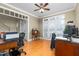 Bright home office with hardwood floors, large window, and neutral paint, offering a workspace at 413 Chadwick Ln, Efland, NC 27243