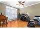 Spacious office area featuring hardwood floors, a ceiling fan, and an abundance of natural light at 413 Chadwick Ln, Efland, NC 27243