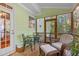 Cozy screened porch features seating area, wooden floors, and view of the backyard at 413 Chadwick Ln, Efland, NC 27243