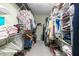 Spacious walk-in closet features ample storage with shelves and hanging racks for clothing at 413 Chadwick Ln, Efland, NC 27243