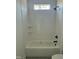 Clean, bright bathroom featuring a white tiled tub-shower, dark fixtures and sleek shelves at 8536 Savage Rd, Spring Hope, NC 27882