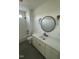 Stylish bathroom with modern fixtures, a round mirror, and a tub-shower combination at 8536 Savage Rd, Spring Hope, NC 27882