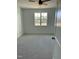 Bright bedroom featuring neutral carpet, ceiling fan, and a window with views of the greenery at 8536 Savage Rd, Spring Hope, NC 27882