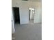 Bright bedroom with neutral carpet, white walls, and a doorway leading to the bathroom at 8536 Savage Rd, Spring Hope, NC 27882