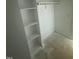 White closet with multiple shelves and a wooden rod for convenient storage at 8536 Savage Rd, Spring Hope, NC 27882