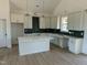 Modern kitchen with island and dark green tile backsplash at 8536 Savage Rd, Spring Hope, NC 27882