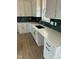 Modern kitchen with white cabinets, quartz countertops, and a farmhouse sink at 8536 Savage Rd, Spring Hope, NC 27882