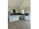 Modern kitchen with white cabinets, quartz countertops, and dark green tile backsplash at 8536 Savage Rd, Spring Hope, NC 27882