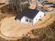 Aerial view of new home, manicured backyard with view of nearby neighborhood at 326 Little Creek Dr, Lillington, NC 27546