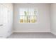 Bright, carpeted bedroom with a large window allowing natural light and scenic outdoor views at 326 Little Creek Dr, Lillington, NC 27546