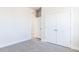 A bedroom features double doors and an open doorway with gray carpet and white trim at 326 Little Creek Dr, Lillington, NC 27546