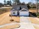 Well-manicured front yard of single story home leading to the welcoming two-car garage at 326 Little Creek Dr, Lillington, NC 27546