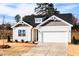 Charming single-story home featuring a two-car garage and professionally landscaped front yard at 326 Little Creek Dr, Lillington, NC 27546