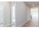 Bright hallway with hardwood floors leads to various rooms in this modern home at 326 Little Creek Dr, Lillington, NC 27546