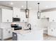 Bright kitchen with white cabinets, a center island and stainless steel appliances at 326 Little Creek Dr, Lillington, NC 27546