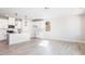 A bright and airy living room with an open concept connects to a white kitchen at 326 Little Creek Dr, Lillington, NC 27546