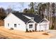 Rear exterior view of the home with a well-maintained lawn and landscaping at 326 Little Creek Dr, Lillington, NC 27546