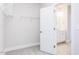 Carpeted walk-in closet with wire shelving seen through a door leading to a bathroom at 326 Little Creek Dr, Lillington, NC 27546