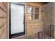 Front entrance with brick facade and storm door at 501 Kendall Dr, Durham, NC 27703