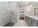Elegant bathroom featuring marble tile, a glass enclosed shower, and double vanity at 698 Magnolia Acres Ln, Fuquay Varina, NC 27526