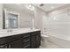 Well-lit bathroom featuring double sinks, vanity cabinet, and shower-tub combination at 698 Magnolia Acres Ln, Fuquay Varina, NC 27526