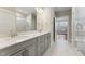 Bright bathroom featuring double sinks, walk in shower, and natural light at 698 Magnolia Acres Ln, Fuquay Varina, NC 27526