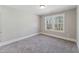 Comfortable bedroom with soft carpeting and a window overlooking the property at 698 Magnolia Acres Ln, Fuquay Varina, NC 27526