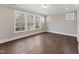 Spacious bedroom with hardwood floors and large windows providing lots of natural light at 698 Magnolia Acres Ln, Fuquay Varina, NC 27526