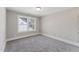 Cozy bedroom featuring soft carpeting and a window overlooking the neighborhood at 698 Magnolia Acres Ln, Fuquay Varina, NC 27526